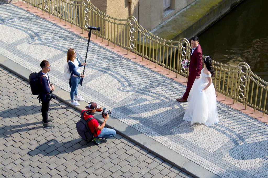 Wedding photographer and his team taking prenup photos with the couple
